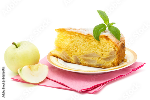 apple sponge cake on the plate with icing sugar and apples