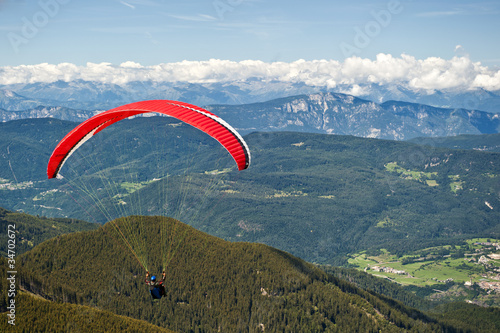 paragliding flying over the Italian Alps