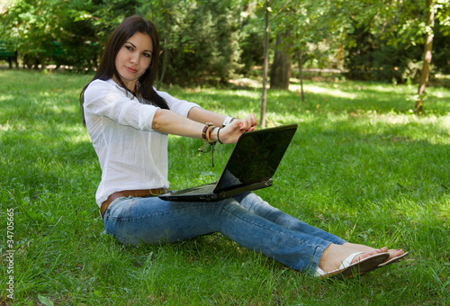 russian girl with a laptop on the grass