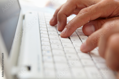 Close up man using computer keyboard