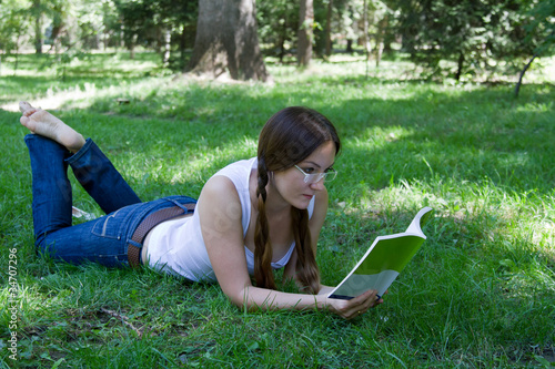 student girl reading a book on the grass © vitmark