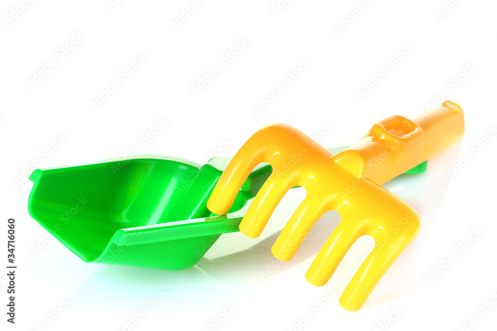 Children's toy rake and shovel isolated on white Children's toy rake and shovel isolated on white