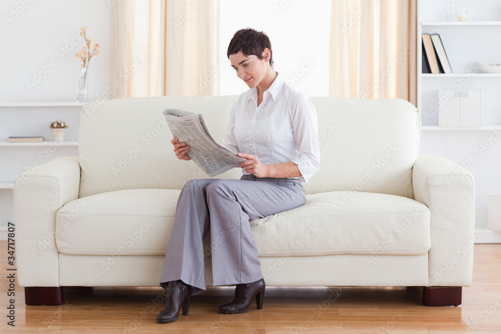 Gorgeous brunette reading the news Gorgeous brunette reading the news