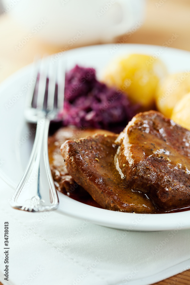 Roast beef with potato dumplings and red cabbage Roast beef with potato dumplings and red cabbage