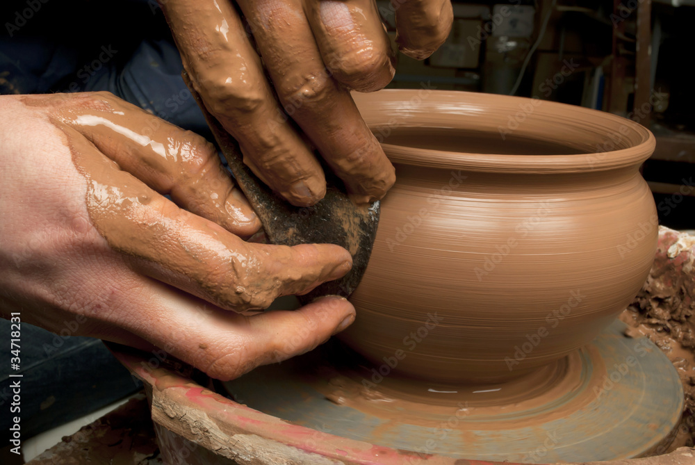 hands of a potter, creating an earthen jar on the circle hands of a potter, creating an earthen jar on the circle