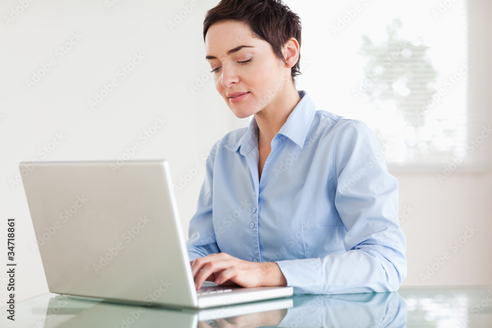 Charming short-haired businesswoman with a laptop Charming short-haired businesswoman with a laptop