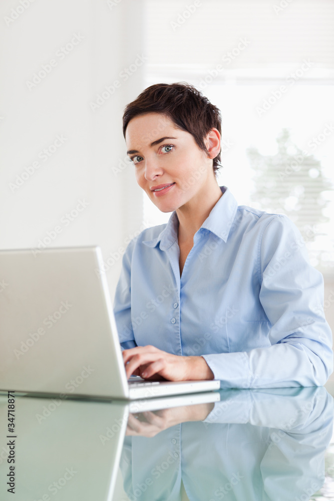 Short-haired businesswoman with a laptop looking into the camera Short-haired businesswoman with a laptop looking into the camera