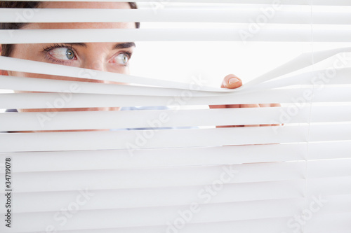 Tableau sur toile Woman peeking out of a window