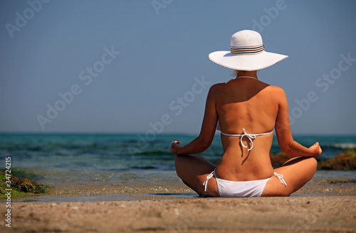 Young woman in bikini relaxing on beach