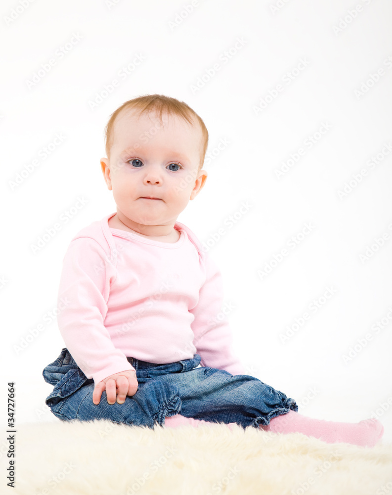 eight-monthly girl in a pink jacket and jeans eight-monthly girl in a pink jacket and jeans