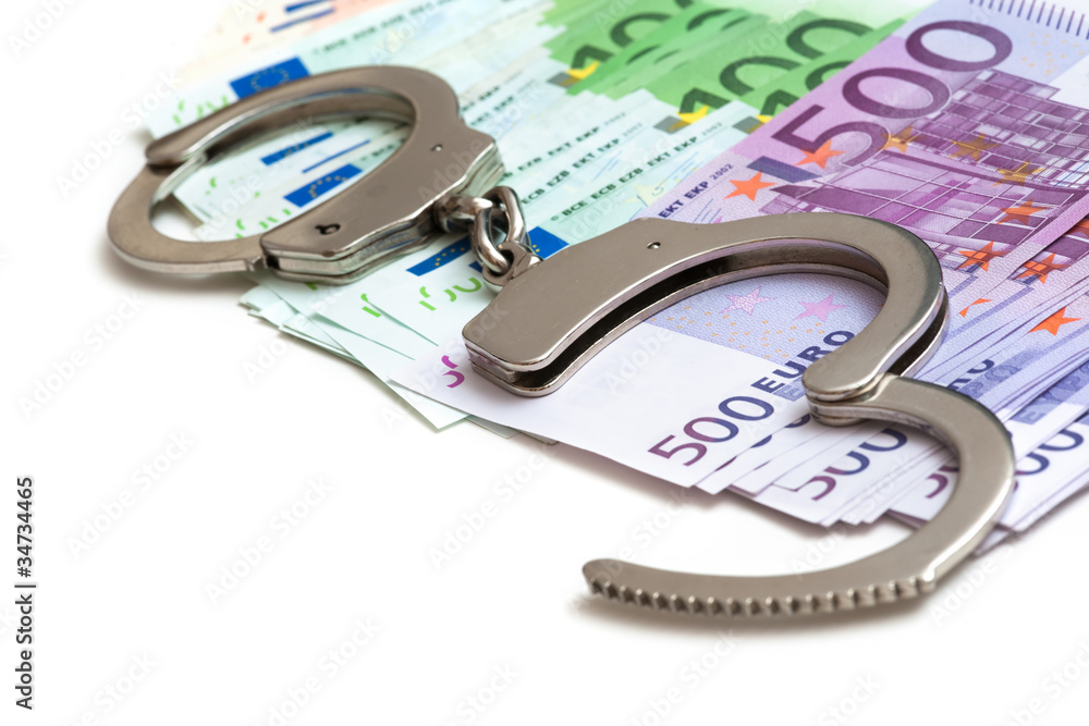 Handschellen und Euro Banknoten Handschellen und Euro Banknoten