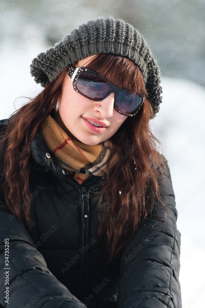 Junge hübsche Frau mit Zahnspange in Winteroutfit Junge hübsche Frau mit Zahnspange in Winteroutfit