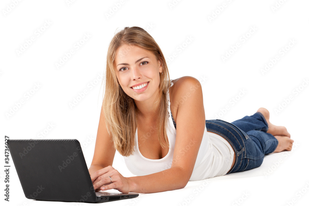 Woman with laptop lying down on the floor Woman with laptop lying down on the floor