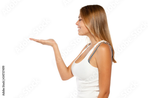 Young woman looking at empty copy space on the open hand palm