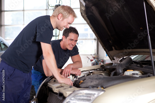 Mechanics in Auto Repair Shop © Tyler Olson