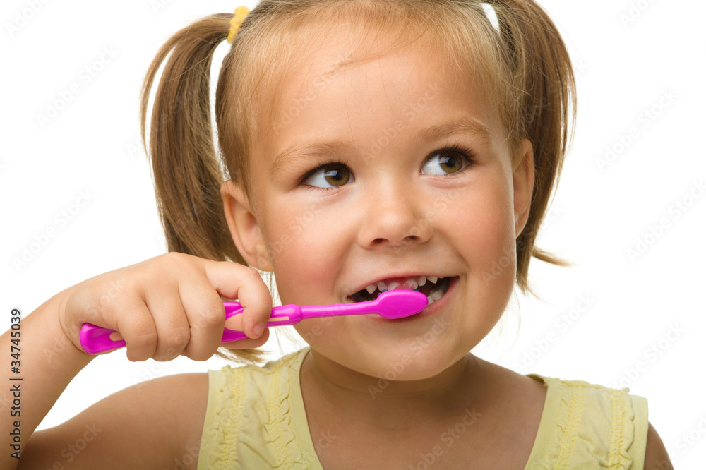 Little girl is cleaning teeth using toothbrush Little girl is cleaning teeth using toothbrush