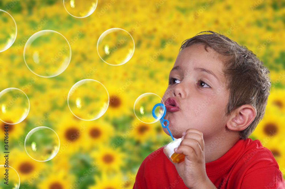 adorable child blowing soap bubbles