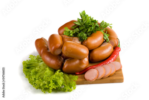 Sausages with lettuce and pepper on white background