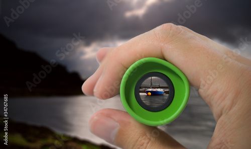 Photos looking through monocular at boat