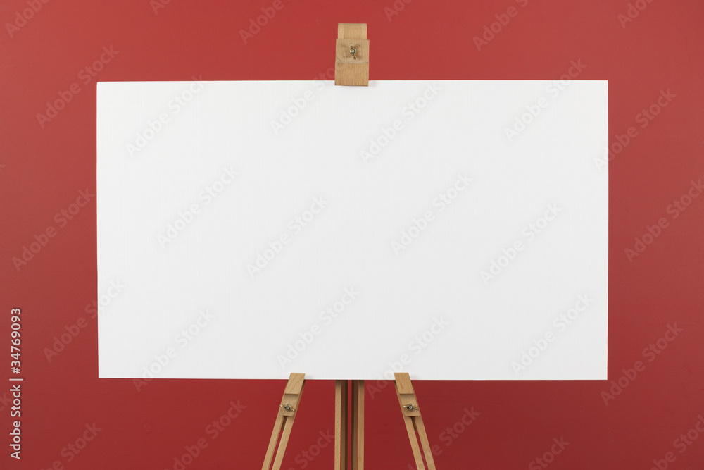 Artist's canvas on easel, red background Artist's canvas on easel, red background
