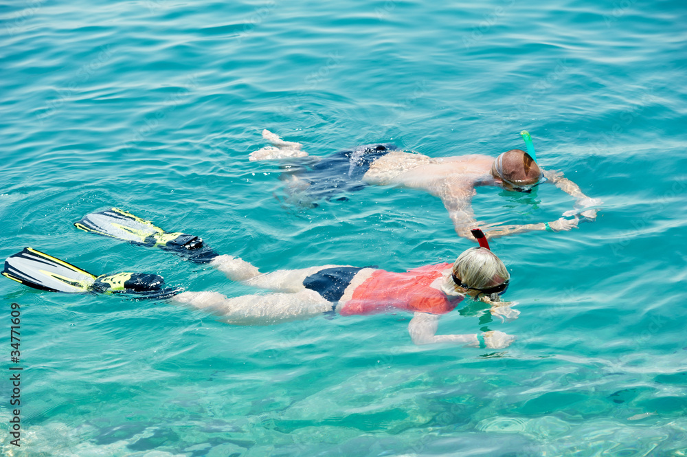 active couple snorkeling at red sea