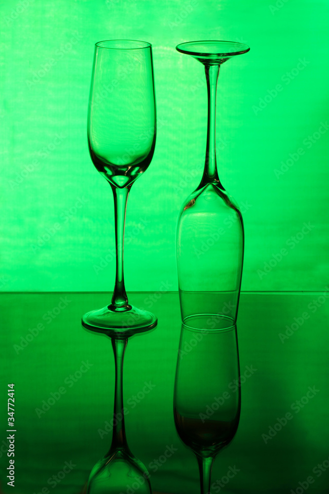 Two tall wineglasses on a green background Two tall wineglasses on a green background