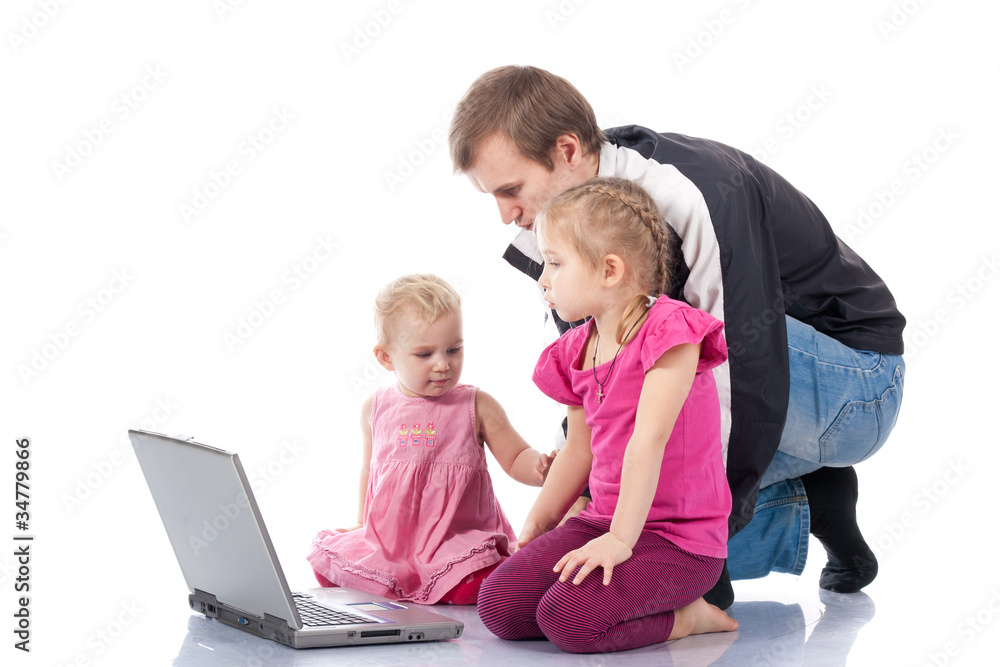 Father with children playing computer games on laptop Father with children playing computer games on laptop