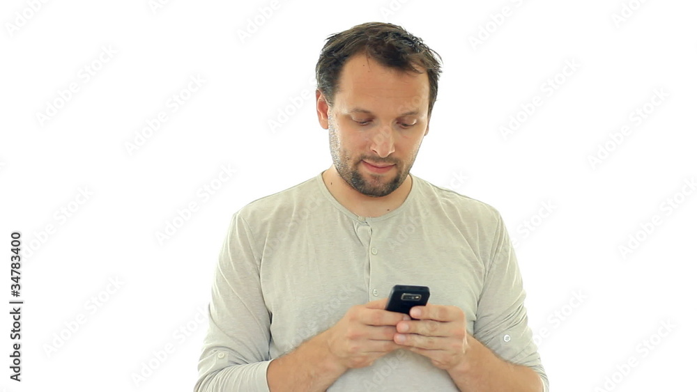 Young man texting, sending sms and smiling, isolated on white Young man texting, sending sms and smiling, isolated on white