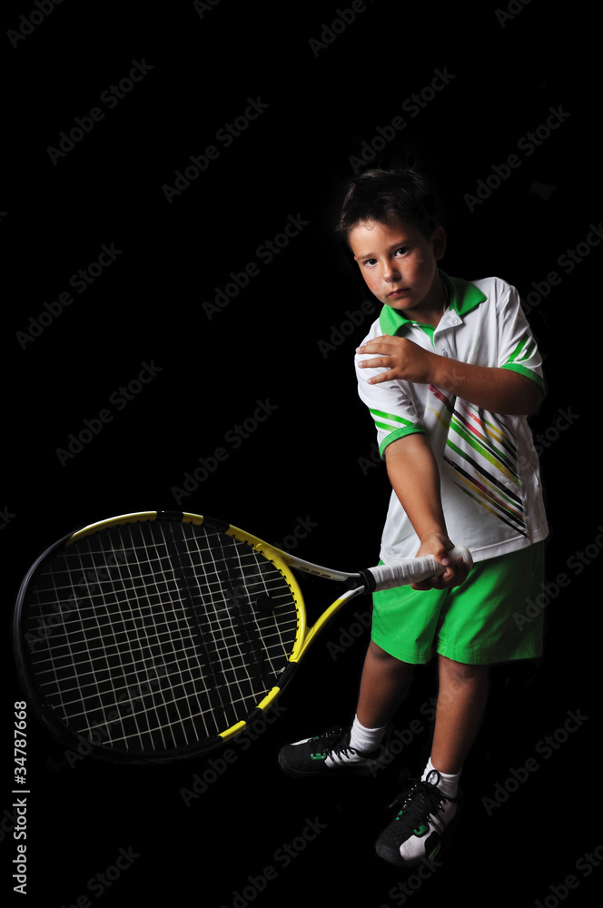 Fototapeta premium Tennis boy playing forehand isolated in black