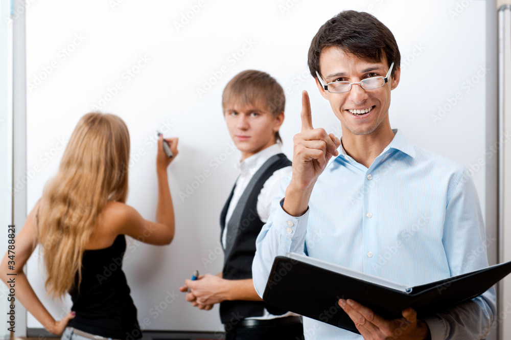 adult teacher with student writing on white board at adult teacher with student writing on white board at