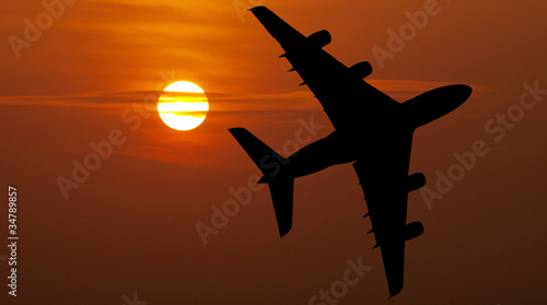 Airliner over red sunset