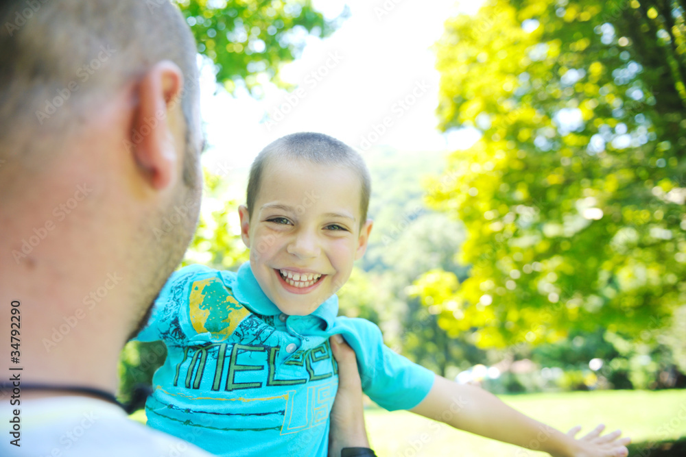 happy father and son have fun at park happy father and son have fun at park