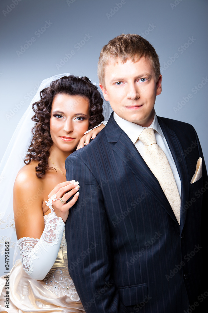 Just married groom and bride on grey Just married groom and bride on grey