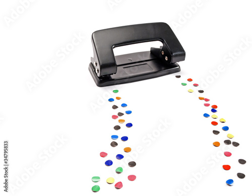 Hole puncher leaves a trail of colored circles.