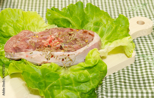 raw turkey meat seasoned on cutting board photo