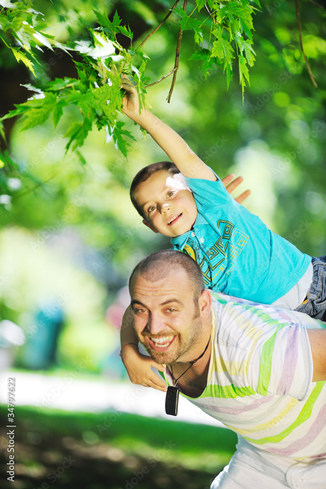 happy father and son have fun at park happy father and son have fun at park