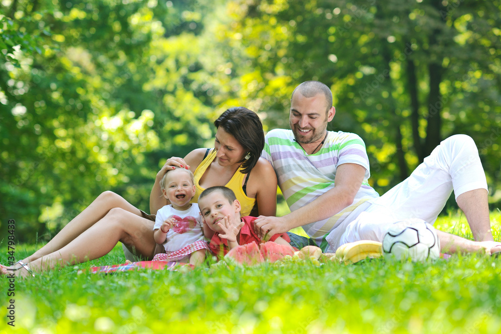 happy young couple with their children have fun at park happy young couple with their children have fun at park