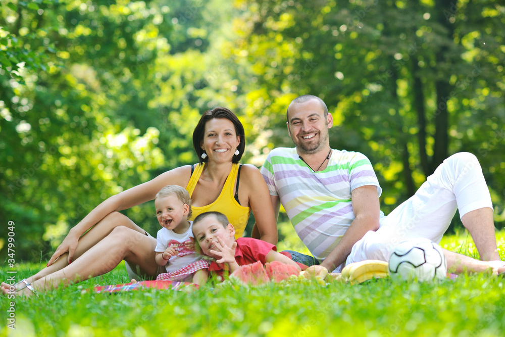 happy young couple with their children have fun at park happy young couple with their children have fun at park