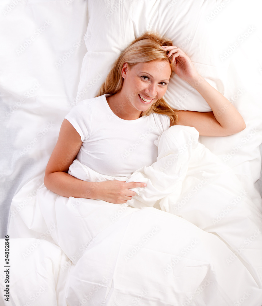 Young woman in bed. Young woman in bed.