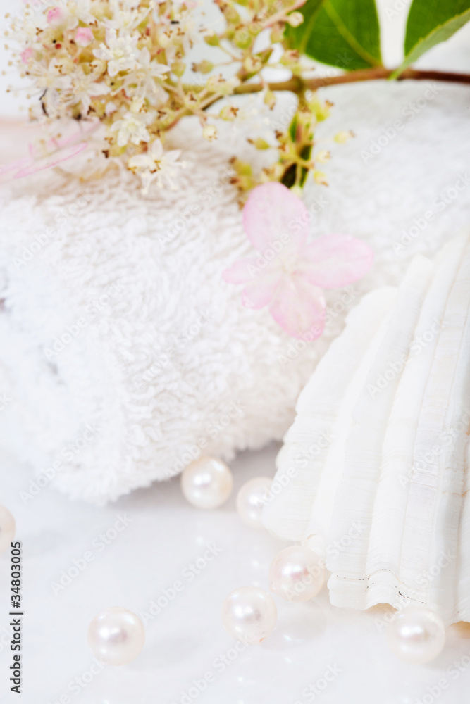wellness concept, shell, pearls towel and flower