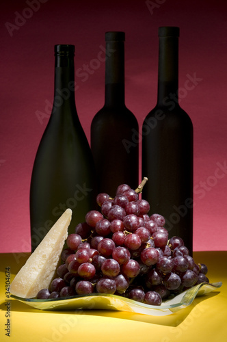 Red grape and wine bottle still life