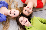 Three girls lying in circle