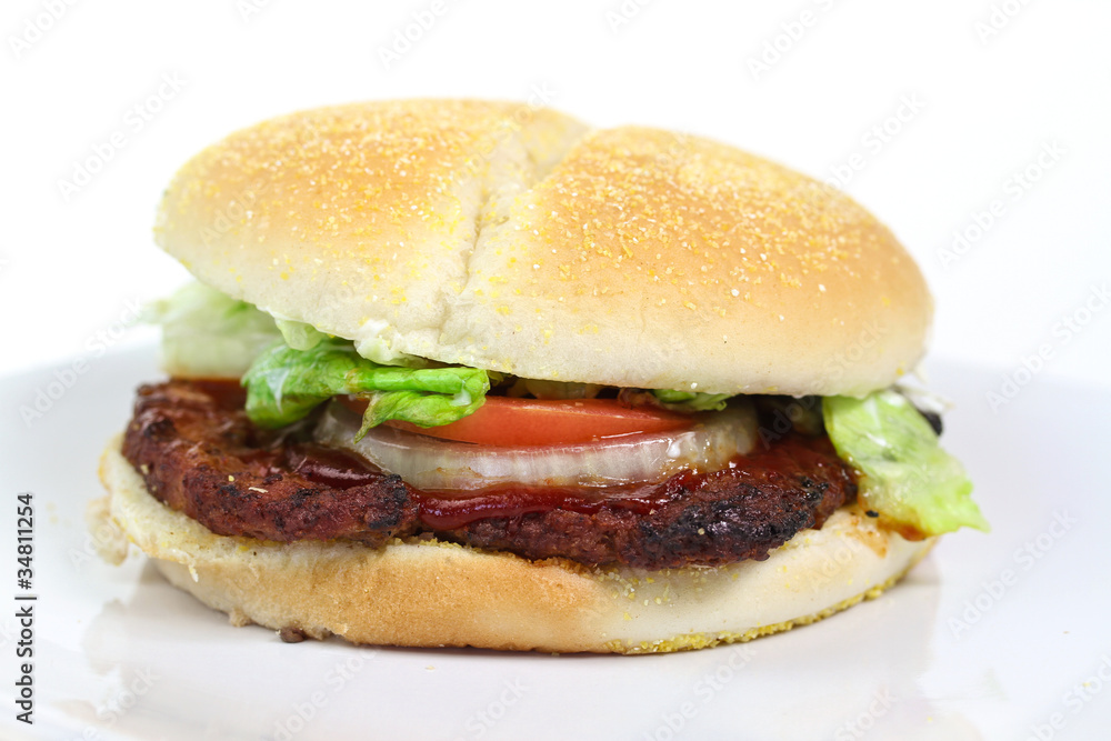 Hamburger with lettuce, tomato and onion isolated on white