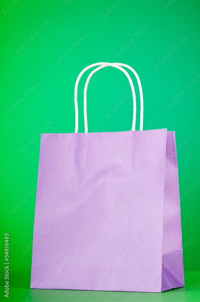 Colourful paper shopping bags against gradient background Colourful paper shopping bags against gradient background