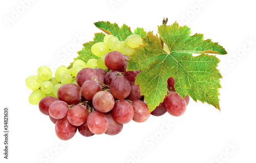 Red and white grapes and green leaf isolated on white