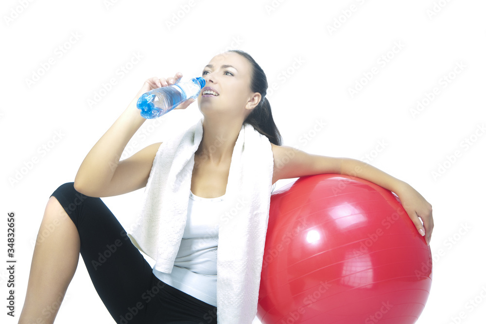 Fototapeta premium sportswoman with bottle of pure water sitting in front of red fi
