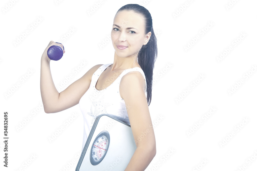 Fototapeta premium Portrait of fitness woman working with small weights