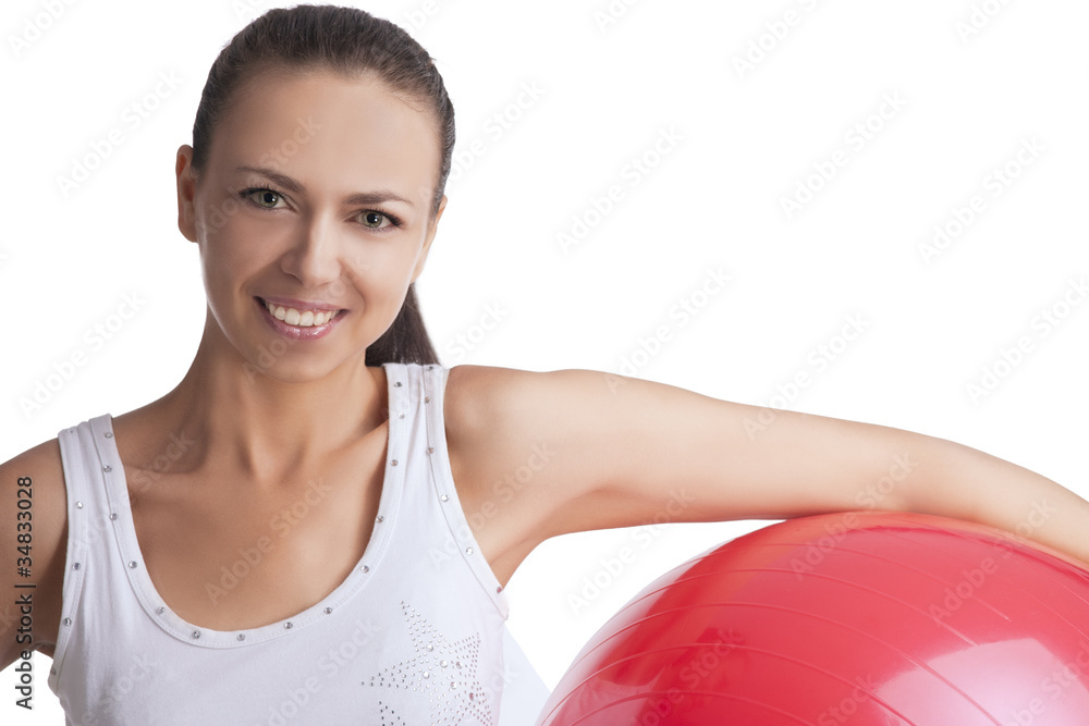Fototapeta premium smiling beautiful caucasian girl with red fitball