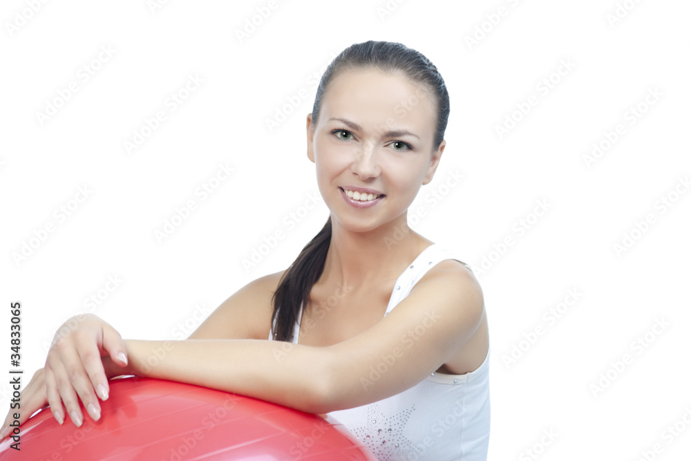 Obraz premium sensual smiling brunette with fitball after exercise isolated on