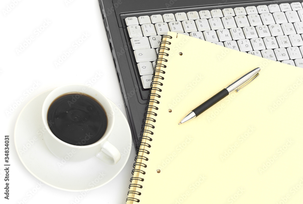 A cup of coffee on a laptop A cup of coffee on a laptop